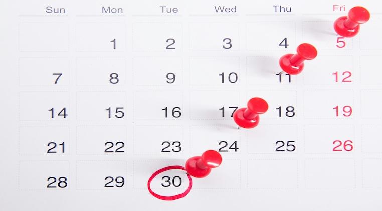 calendar with red stick pins